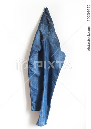 pair of blue jeans hanging on a wall 29234672