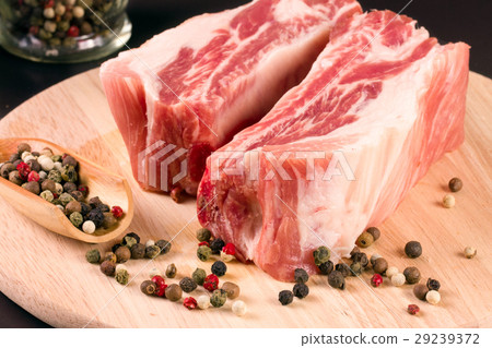 piece of pork on the cutting board a dark piece of pork on the cutting board a dark 29239372