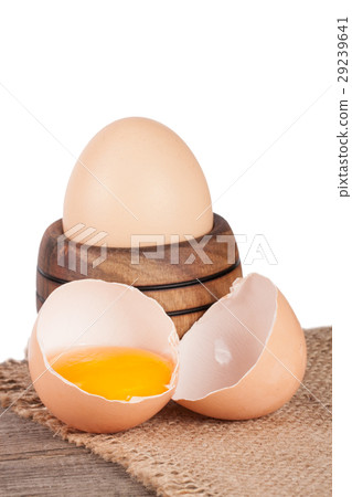 egg in a wooden bowl on a board with sacking on 29239641