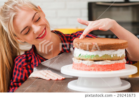 Woman makes a biscuit cake. Sweets for selling. Woman makes a biscuit cake. Sweets for selling. 29241673