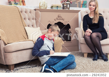 A boy writing letter to Santa with his mother and A boy writing letter to Santa with his mother and 29241932