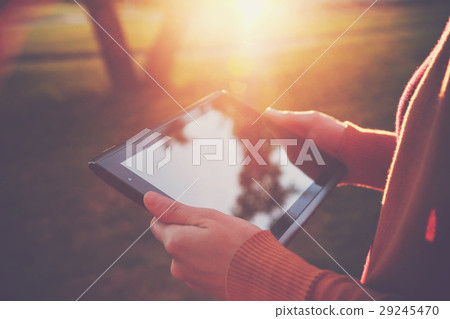 hands holding digital tablet pc in summer light hands holding digital tablet pc in summer light 29245470