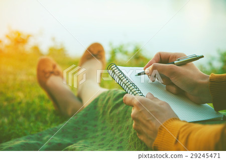 female hands with pen writing on notebook female hands with pen writing on notebook 29245471
