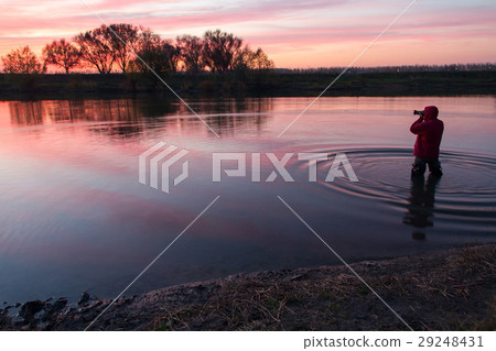 The man costs in the small river. 29248431