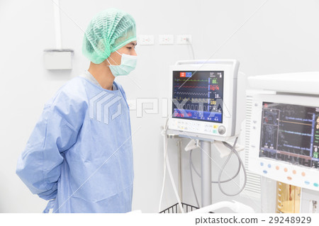 Surgeon looking at medical equipment   29248929