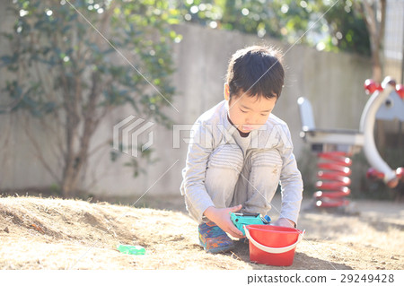 Child playing with mud by toys 29249428