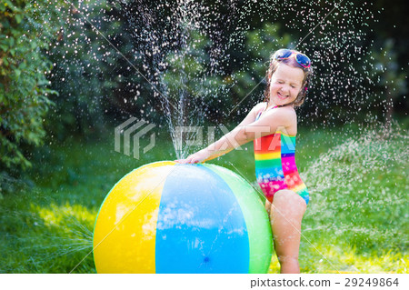 Little girl with toy ball garden sprinkler Little girl with toy ball garden sprinkler 29249864