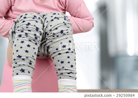 Children's legs hanging down from a chamber-pot Children's legs hanging down from a chamber-pot 29250984