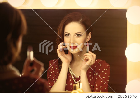 beautiful young woman holding her lipstick 29252570