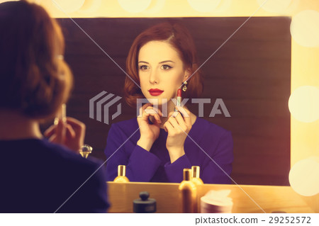 beautiful young woman holding her lipstick 29252572