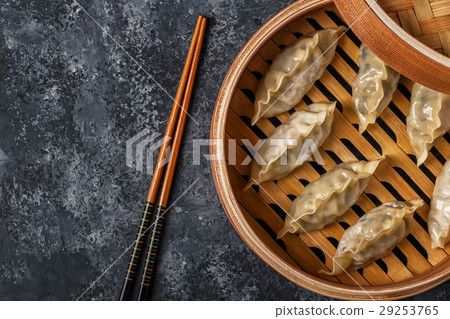 Fresh dumplings on a dark stone background. 29253765