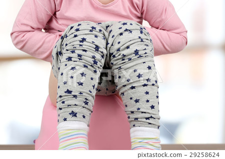 Children's legs hanging down from a chamber-pot Children's legs hanging down from a chamber-pot 29258624