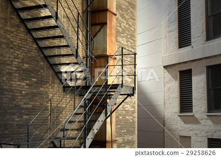 old brick building with fire escape stairs 29258626