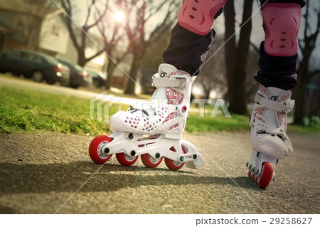 Small girl roller skating outdoor 29258627