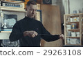 Electrician in his workshop twists black wires to 29263108