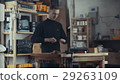 The tall man in the black turtleneck working with 29263109