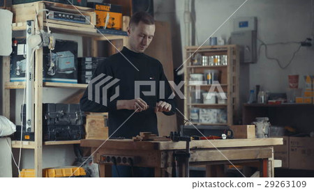 The tall man in the black turtleneck working with 29263109