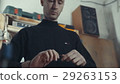 The tall man in the black turtleneck working with 29263153