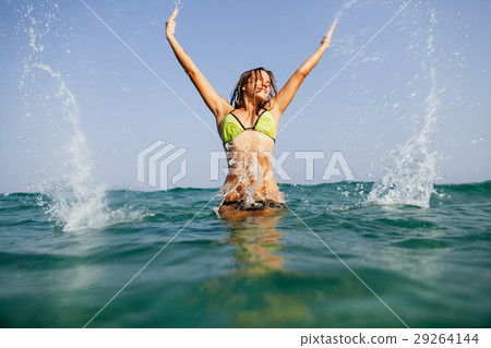 sexy bikini girl happy jump sea waves splash 29264144
