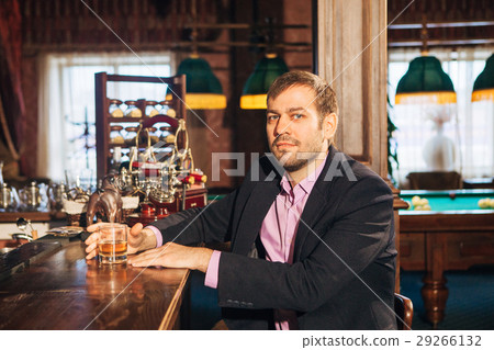 young man talking to a bartender in the bar 29266132