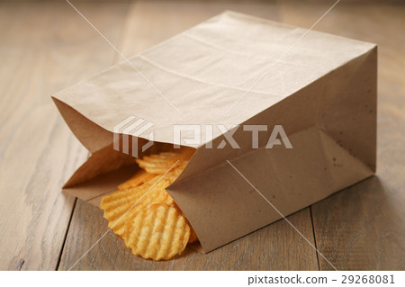 rippled potato chips with paprika in paper bag 29268081