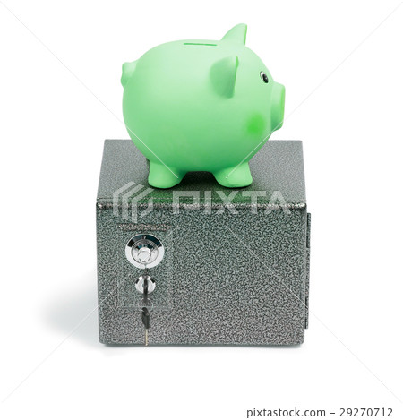 Green ceramic piggy bank standing on a safe Green ceramic piggy bank standing on a safe 29270712
