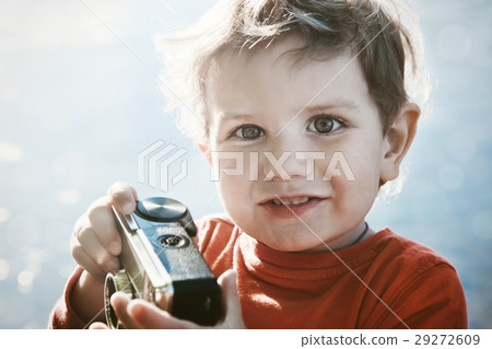 smiling cute boy with retro camera in sunshine 29272609