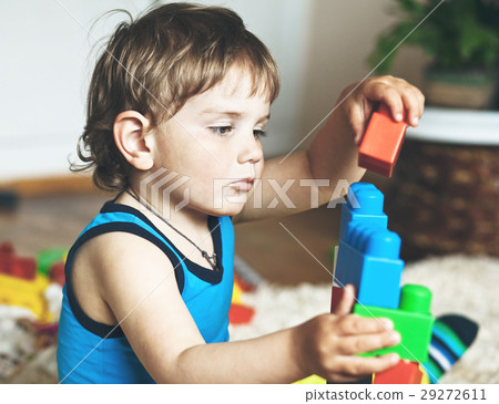 cute boy playing with toy blocks and bricks 29272611