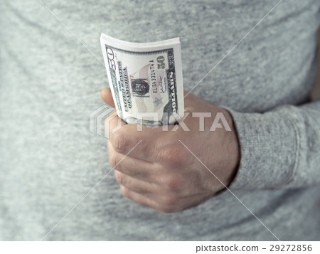 Hands hold dollars 29272856