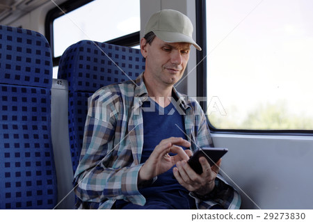 Man with smartphone in a train 29273830