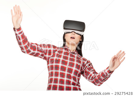 Girl in VR surprised looking up and playing game. Girl in VR surprised looking up and playing game. 29275428