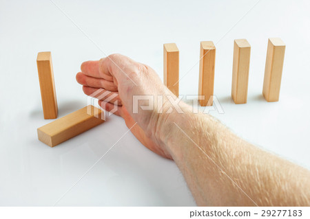 Hand stopping dominoes falling Hand stopping dominoes falling 29277183