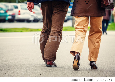 Man and woman walk along the streets, back view. Man and woman walk along the streets, back view. 29277265