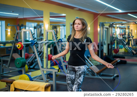 athletic young woman in sportswear exercising with athletic young woman in sportswear exercising with 29280265