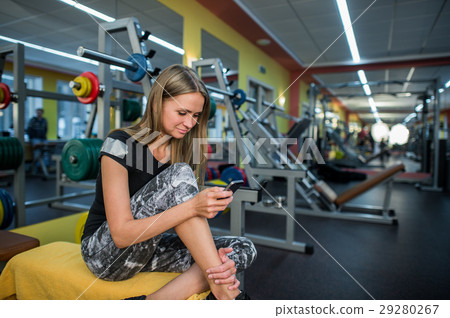 Young woman using phone in gym. Young woman using phone in gym. 29280267