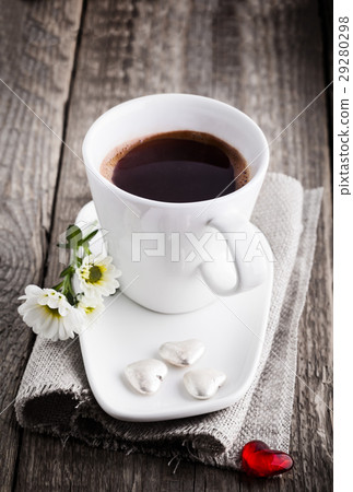 Cup of coffee served on a wooden surface 29280298