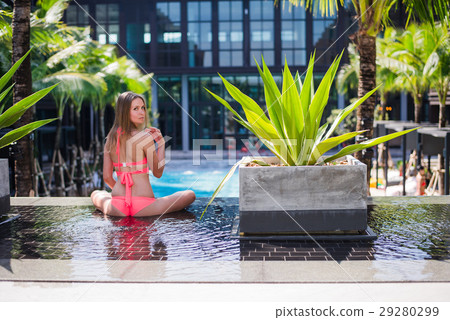 An attractive young woman doing yoga beside the An attractive young woman doing yoga beside the 29280299