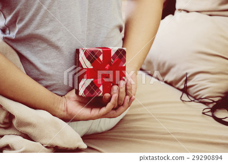 Man is hiding gift behind his back 29290894