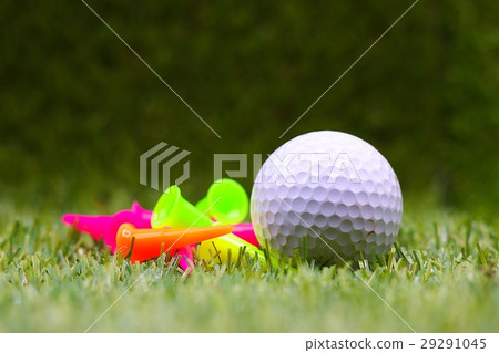 Golf ball with tee are on green grass Golf ball with tee are on green grass 29291045