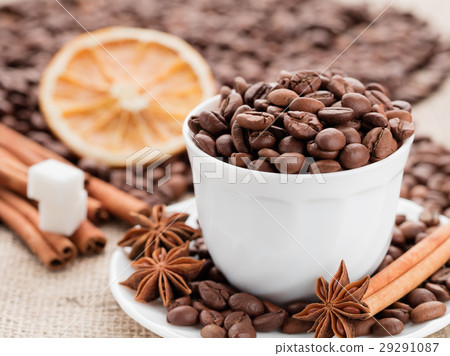 Grains coffee in cup. Cinnamon, anise. Dried lemon Grains coffee in cup. Cinnamon, anise. Dried lemon 29291087