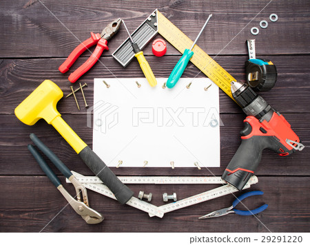 The tool building on a wooden background around The tool building on a wooden background around 29291220