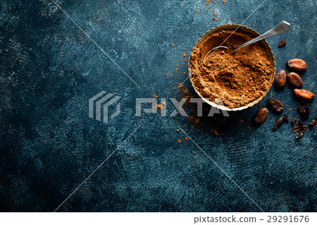Cocoa powder and cacao beans on dark background 29291676