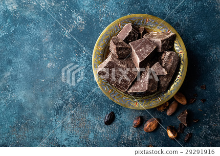 Dark chocolate pieces crushed and cocoa beans Dark chocolate pieces crushed and cocoa beans 29291916