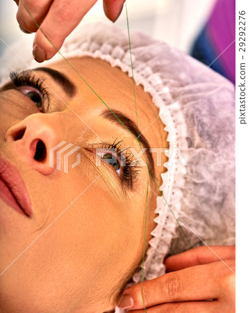 Eyebrow threading of woman middle-aged in spa Eyebrow threading of woman middle-aged in spa 29292276