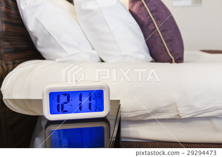 Alarm clock electronic stands on a bedside table 29294473