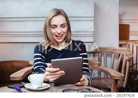Young female student is chatting on digital tablet 29297426