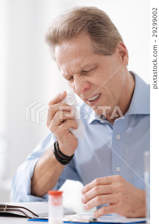 Portrait of sick man while wrinkling his nose 29299002