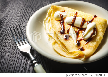 Crepe with whipped cream and chocolate sauce Crepe with whipped cream and chocolate sauce 29302081