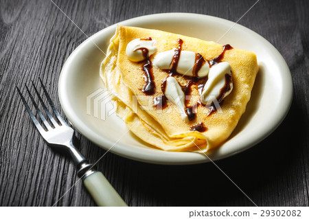 Crepe with whipped cream and chocolate sauce Crepe with whipped cream and chocolate sauce 29302082