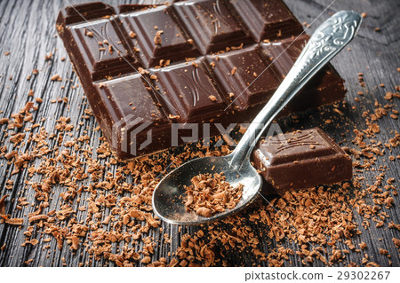 dark chocolate and spoon on dark wooden background 29302267
